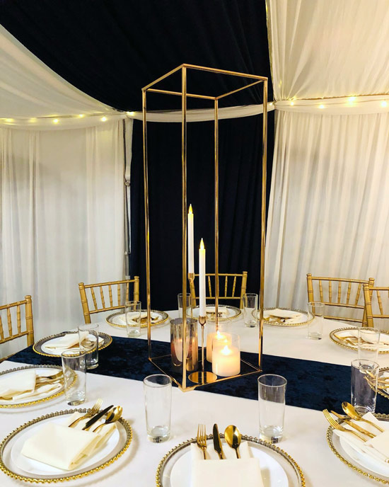 black white and gold wedding décor centrepiece and candles